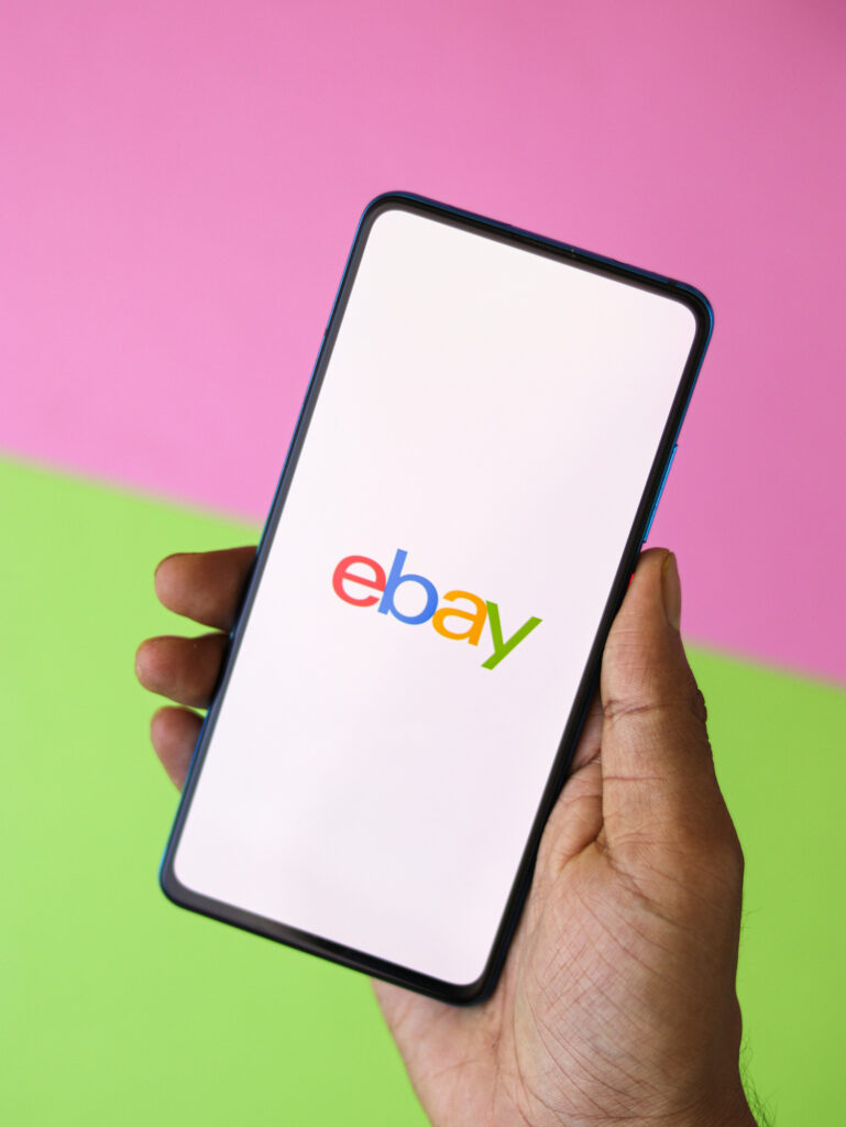 hand holding phone with ebay app open