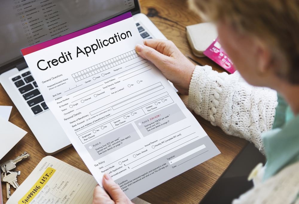 woman holding blank credit application in her hand
