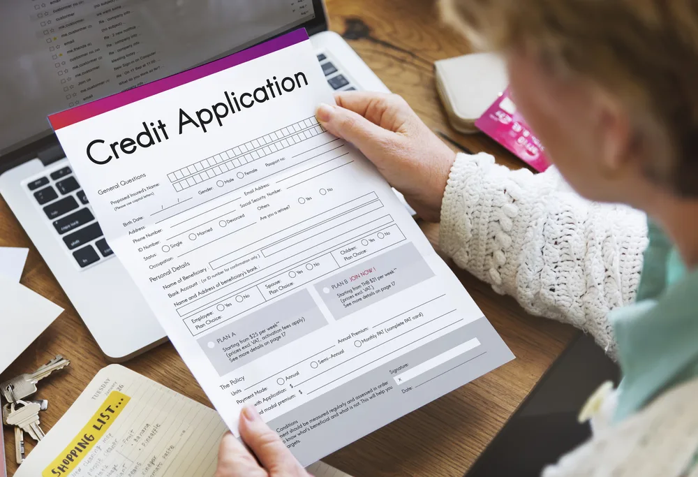 woman holding blank credit application in her hand